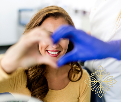 happy smiling woman and doctor forming a heart with their hands showing excellent patient care